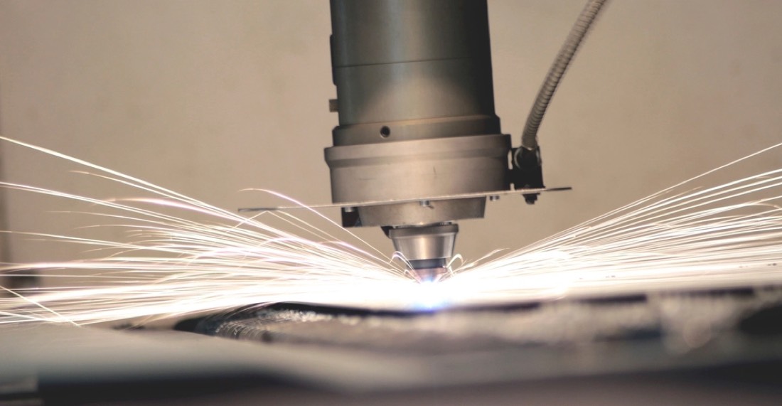 Industrial laser cutting a metal sheet